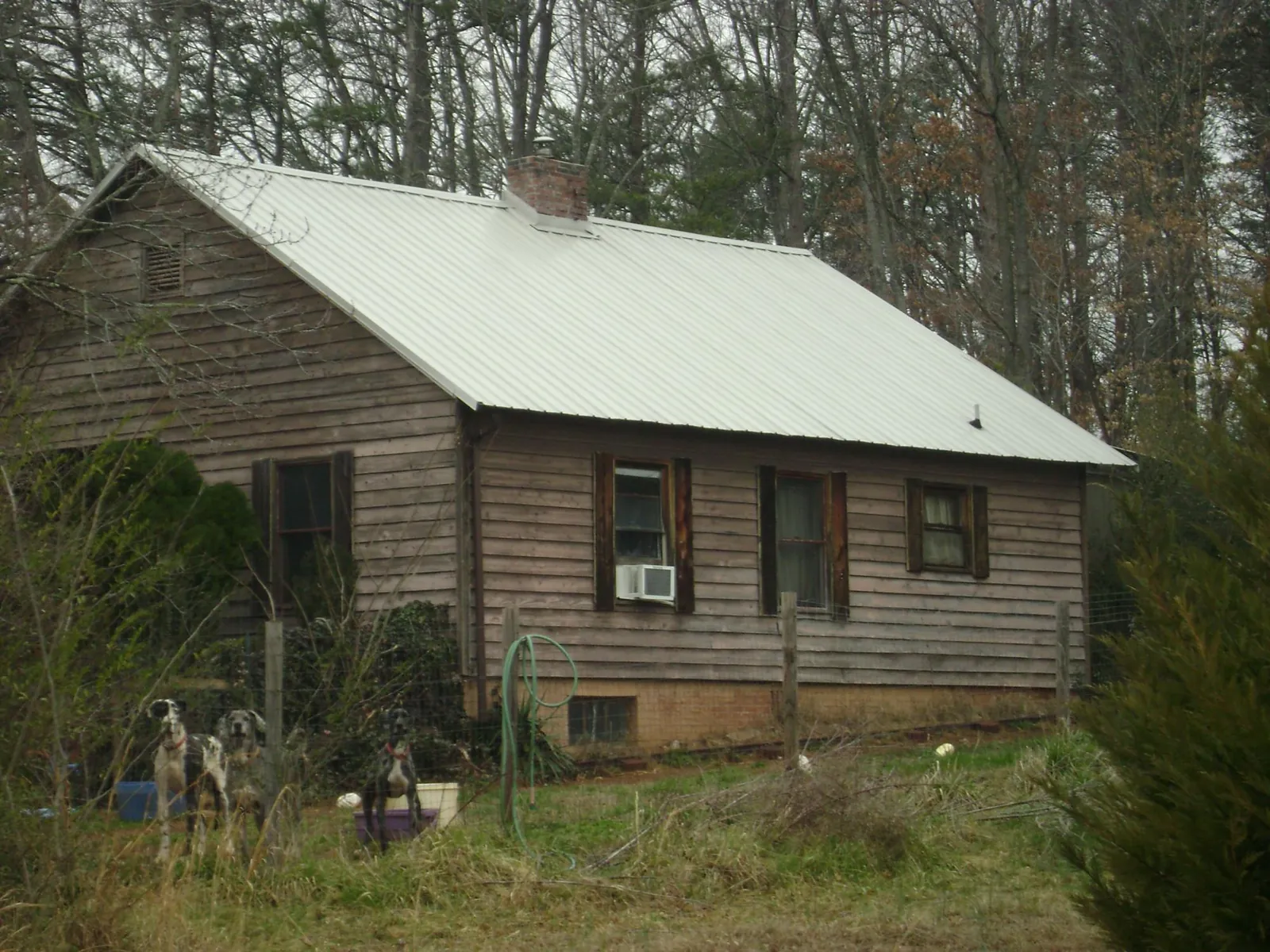 White metal roof on an old wood sided farmhouse, from a Metal Roof Installation job in Keithsburg